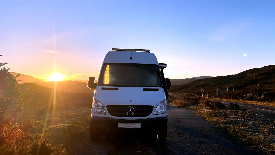 White-campervan-at-sunrise-mountains-scotland White-campervan-at-sunrise-mountains-scotland