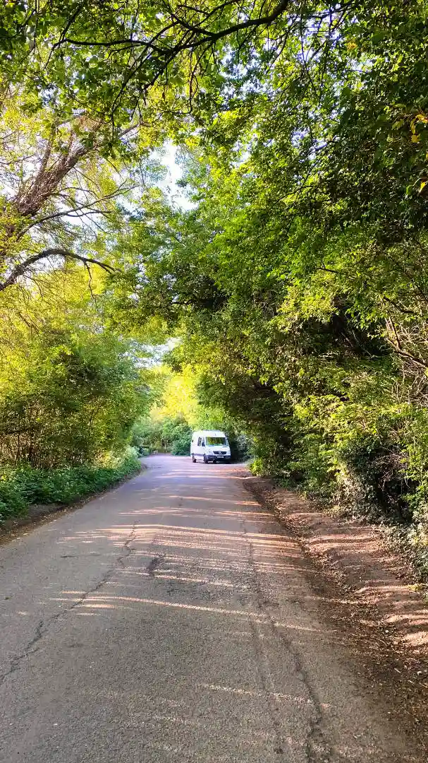 mercedes-sprinter-camper-parked-up-in-shaded-country-road