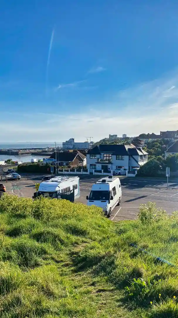 two-campervans-parked-up-on-the-coast